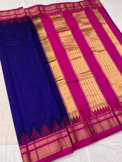 Beautifully draped royal blue and pink silk saree with intricate golden zari border and rich pallu