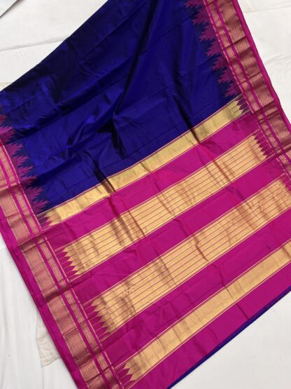 Gorgeous royal blue and pink silk saree fully displayed to showcase detailed golden zari weaving.