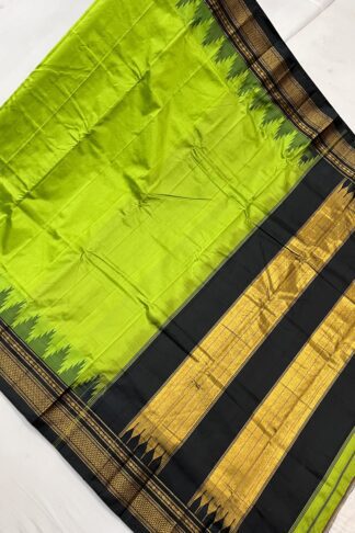 Full-length lime green saree with broad black-gold pallu and woven zari border – festive silk cotton drape.