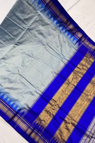 Ilkal saree displayed fully, showcasing the striking blue hues, signature contrast pallu, and intricate golden zari detailing.