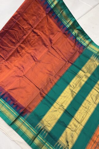 Rich burnt orange and teal green Ilkal saree with gold zari temple border and signature Tope Teni pallu.