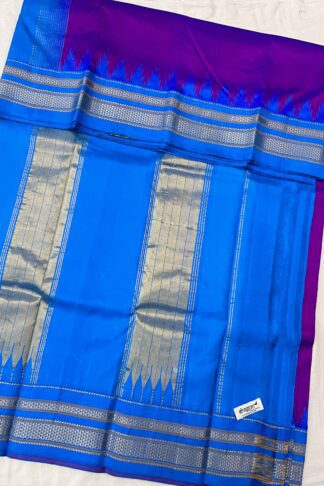 Traditional Ilkal silk saree with golden and silver zari pallu in a striking magenta-blue combination.