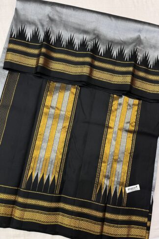 A beautifully draped Grey and Black Pure Silk Ilkal Saree showcasing its intricate gold zari pallu and traditional weaving pattern.