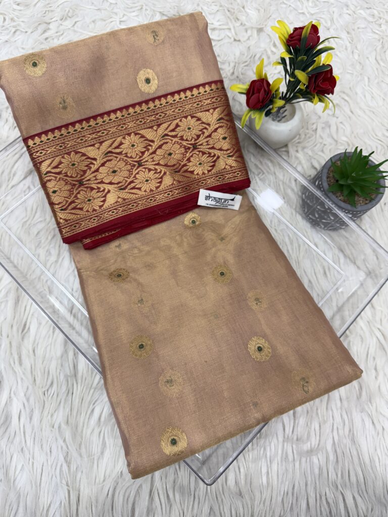 Folded beige Chanderi tissue silk saree with circular gold motifs and maroon floral border