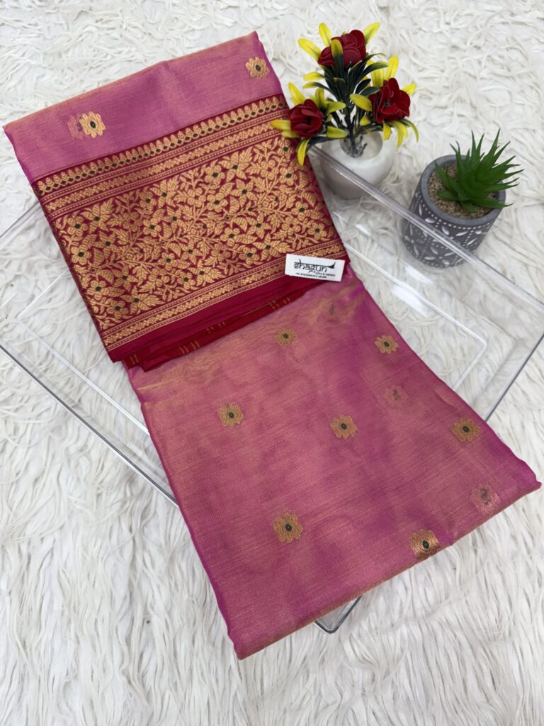 Pink Chanderi tissue silk saree with golden zari floral border displayed with flower pots